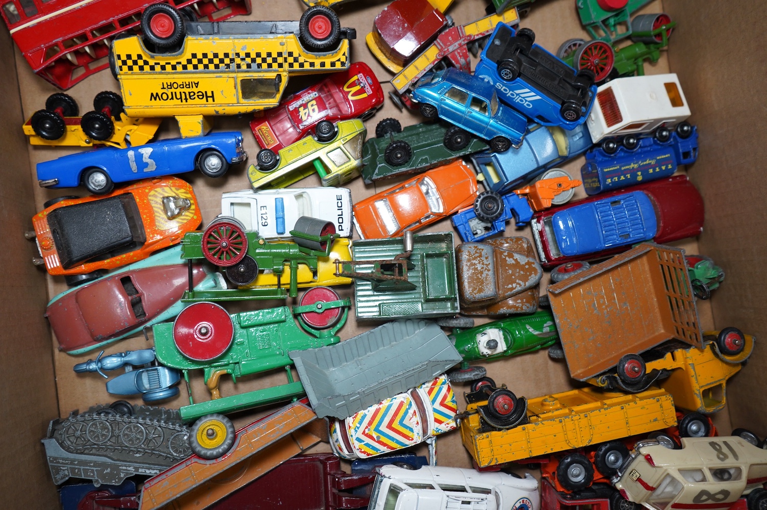 A collection of approximately ninety Dinky Toys, Corgi Toys, Matchbox Series, etc. for restoration, comprising of 1950s to 1970s diecast models of cars, commercial vehicles, military vehicles, etc. Condition - poor, most